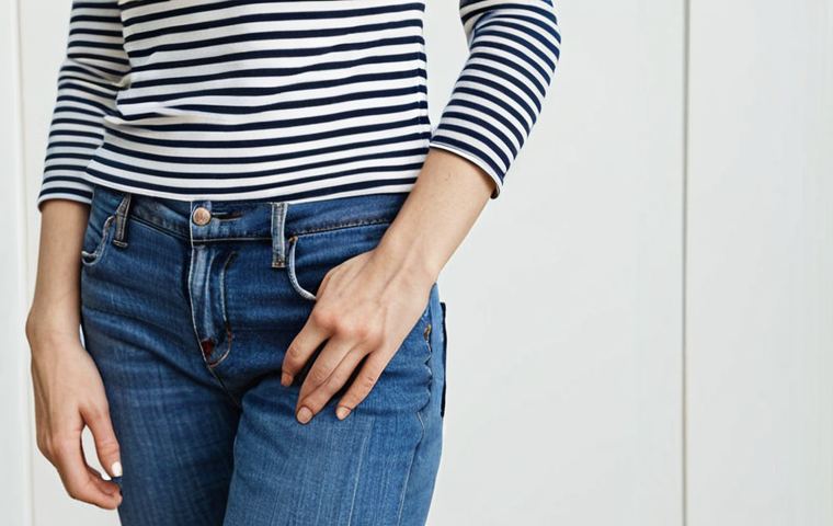 **
Prompt: "A woman wearing a Breton striped top with blue jeans. Classic, minimalist style. Clean background, natural light."
**
